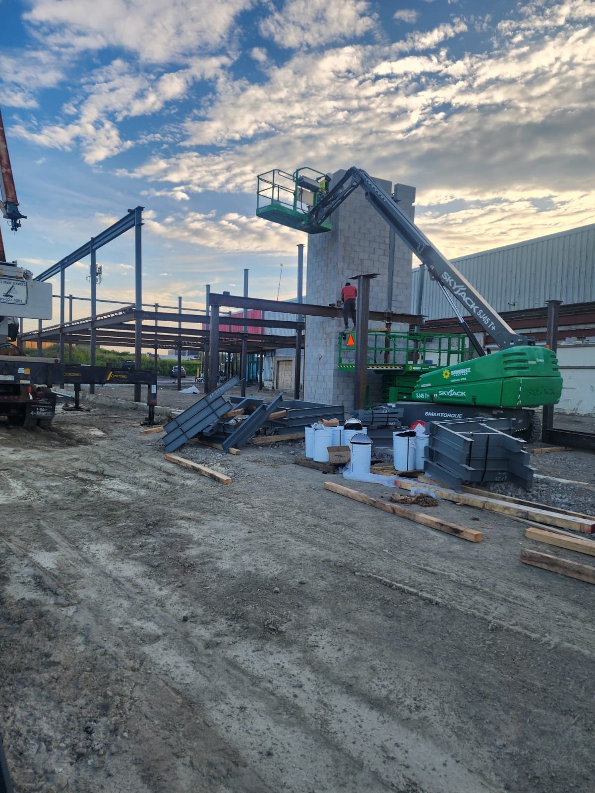 Commercial construction project with structural steel framing and masonry work in progress