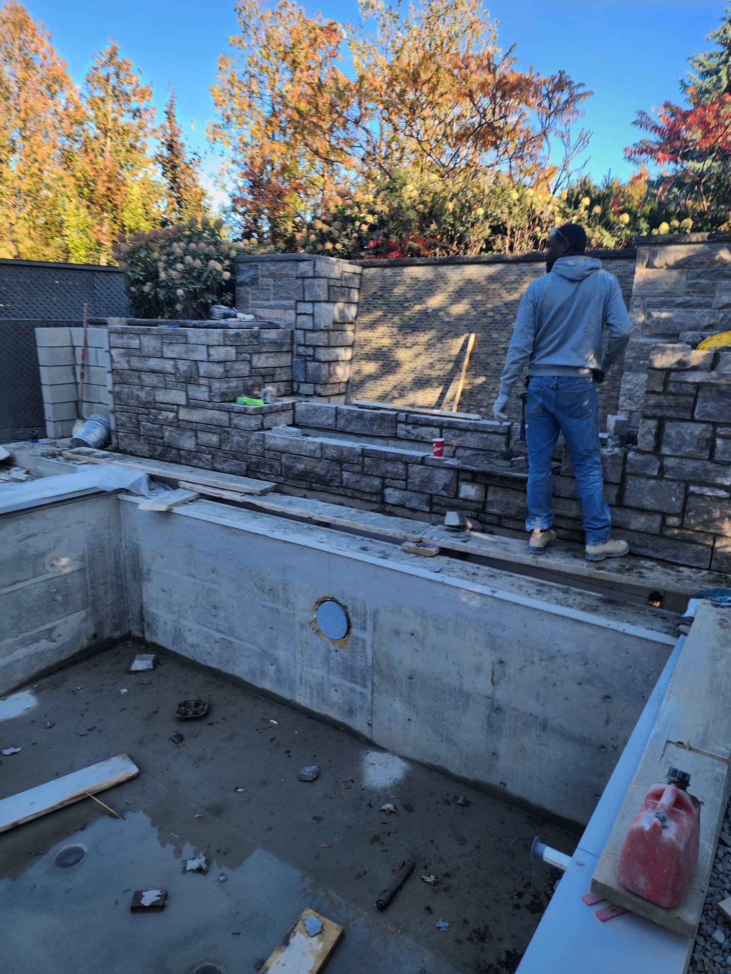 Retaining wall and pool construction project in a residential backyard