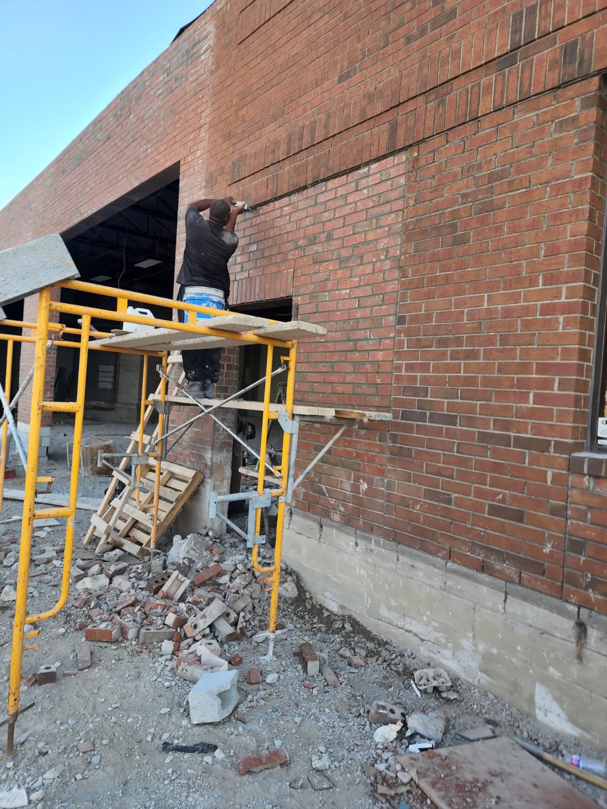 Residential construction showing a new opening formed in an existing brick wall