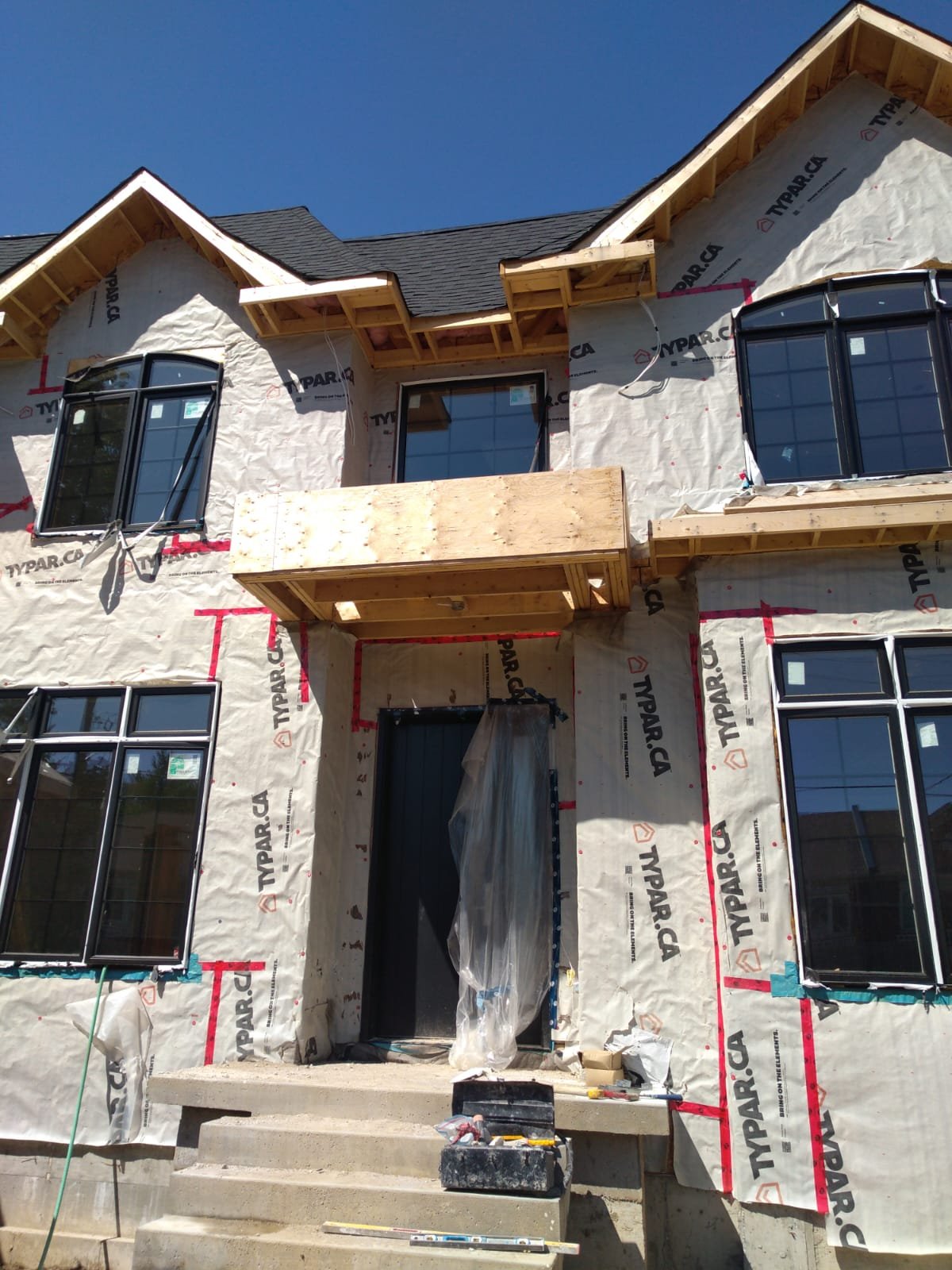 Residential facade wrapped and prepared for exterior finishing