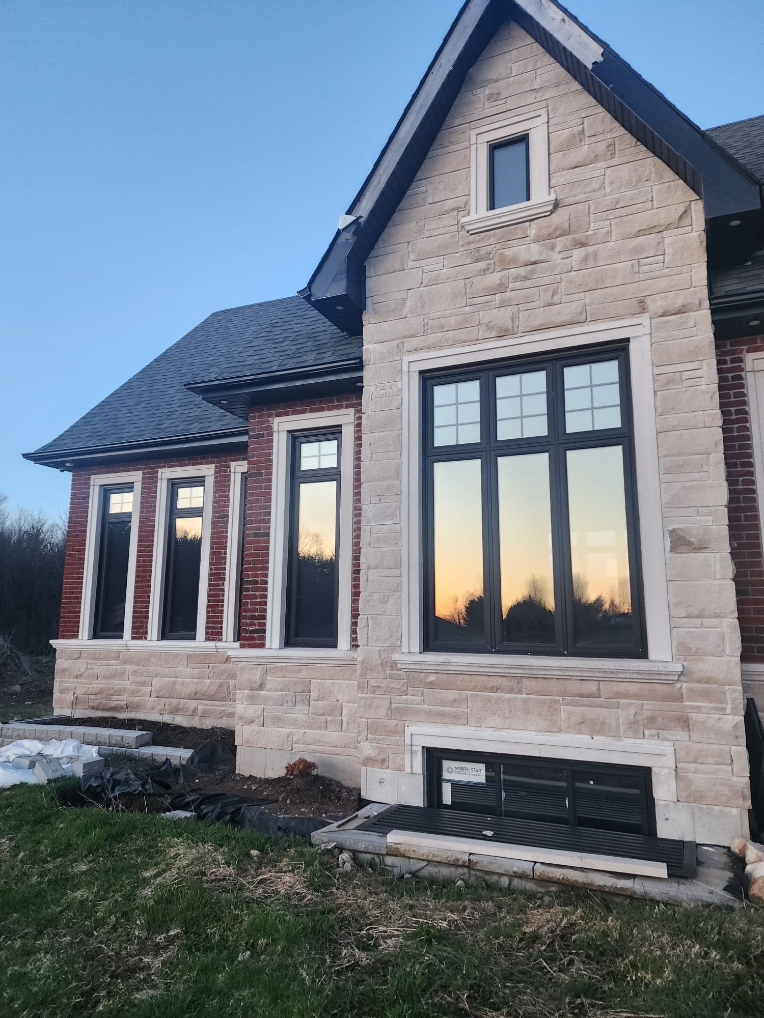 Finished home with stone and brick exterior and prominent gable details