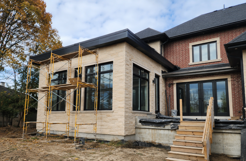 Organized residential construction progress with masonry or exterior-envelope work underway